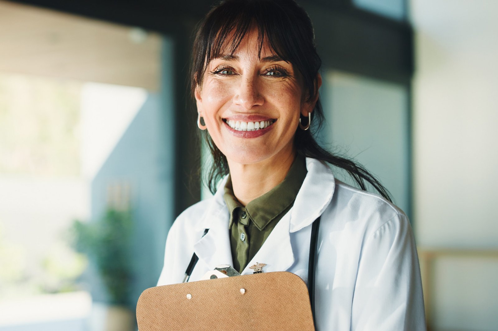 smiling female doctor holding clipboard