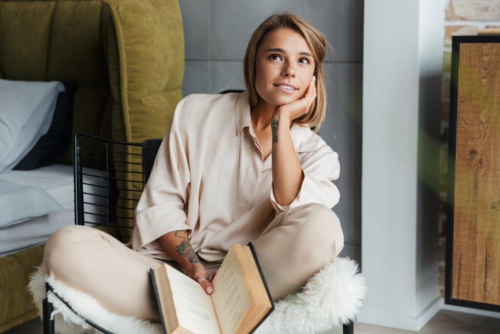 unfocused-woman-trying-to-read-a-book-in-cozy-chair